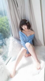 Stunning Asian Girl in Blue Cardigan Sitting by the Window Mobile Wallpaper