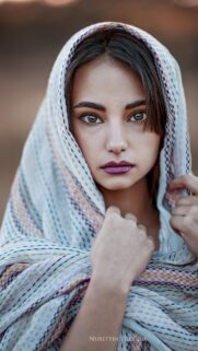 Stunning Portrait of a Woman with a Patterned Headscarf Mobile Wallpaper