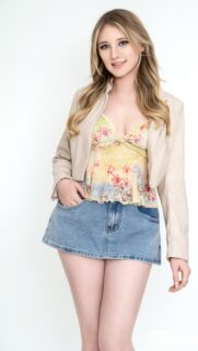 Beautiful Blonde Girl in Floral Top and Denim Skirt Mobile Wallpaper