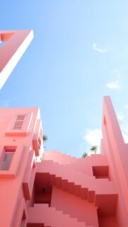 Minimalist Pink Architecture Wallpaper with Staircase and Clear Blue Sky