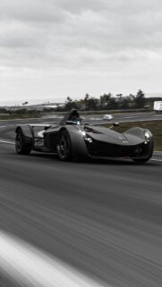 Stunning BAC Mono Supercar Speeding on Coastal Highway Mobile Wallpaper