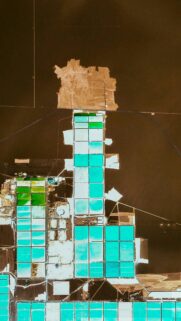 Aerial View of Vibrant Turquoise Salt Evaporation Ponds Wallpaper