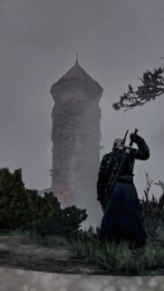 Geralt of Rivia Standing Before a Mysterious Foggy Tower Phone Wallpaper