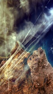 Satellite View of Earth Coastline with Atmospheric Contrails Wallpaper