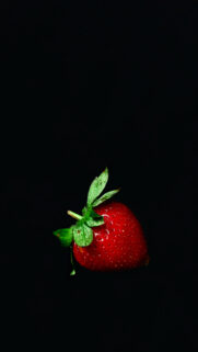 Vibrant Single Strawberry on Solid Black Background High Quality Mobile Wallpaper
