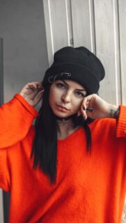 Stunning Portrait of a Girl in an Orange Sweater and Black Beanie Aesthetic Wallpaper