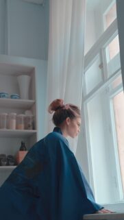 Pensive Woman in Blue Kimono Looking Out Window Aesthetic Mobile Wallpaper