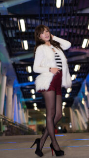 Stunning Asian Fashion Model in White Faux Fur Coat and Heels Mobile Wallpaper
