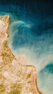 Breathtaking Aerial View of Coastal Sand and Ocean Waters Wallpaper