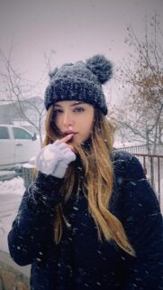 Stunning Young Woman in Winter Snowscape Aesthetic Wallpaper