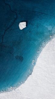 Stunning Aerial View of Arctic Iceberg and Frozen Ocean Mobile Wallpaper