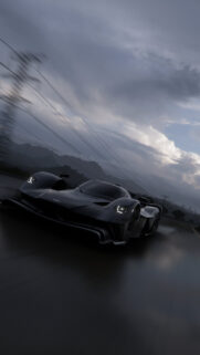 Aston Martin Valkyrie Speeding on Rainy Road Mobile Wallpaper
