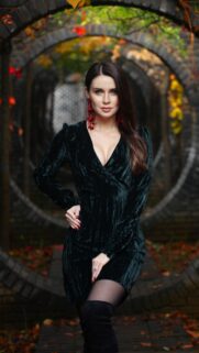 Elegant Woman in Green Velvet Dress Fall Garden Wallpaper