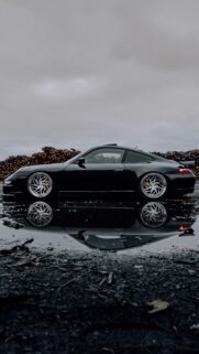 Stanced Black Porsche 911 Sportscar with Puddle Reflection Mobile Wallpaper