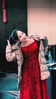 Beautiful Asian Woman in Elegant Red Lace Dress and Winter Jacket Mobile Wallpaper