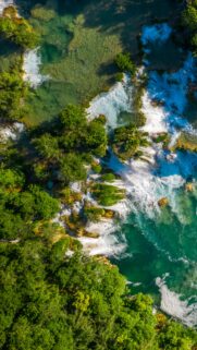 Stunning Aerial View of Tropical Waterfall and Emerald River Mobile Wallpaper