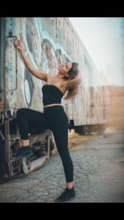 Stunning Woman Posing by Graffiti Train Car Urban Style Wallpaper