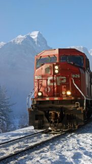 Stunning Canadian Pacific Train in Snowy Mountain Landscape Wallpaper
