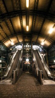 Symmetrical Subway Station Escalators at Night High Resolution Mobile Wallpaper