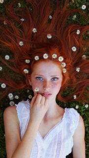 Stunning Redhead Girl with Daisies in Hair Wallpaper for Mobile