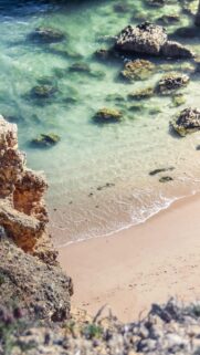 Stunning Aerial View of Clear Turquoise Ocean Water and Sandy Beach Mobile Wallpaper