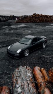 Stanced Black Porsche 911 Sportscar Industrial Timber Yard Wallpaper