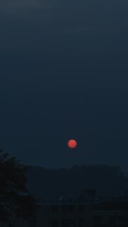 Minimalist Dark Sky with Vibrant Red Sun Mobile Wallpaper