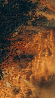 Stunning Satellite View of Desert Dunes and Dark Rocky Terrain Mobile Wallpaper