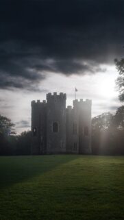 Stunning Medieval Stone Castle Under Dramatic Stormy Sky Wallpaper for Mobile