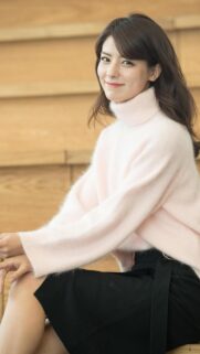 Beautiful Smiling Young Woman in Soft Pink Turtleneck Sweater Wallpaper