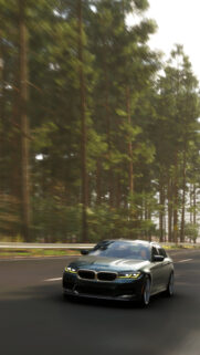 Speeding BMW M5 Sedan Driving Through Forest Road Wallpaper