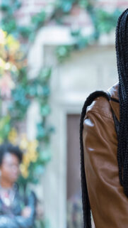 Stylish Woman with Braided Hair and Leather Jacket Mobile Wallpaper
