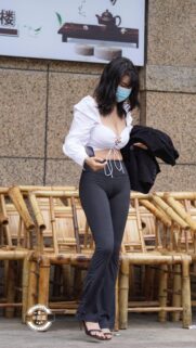 Stylish Young Woman in White Crop Top and Leggings Urban Street Fashion Wallpaper
