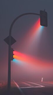 Minimalist Traffic Light in Thick Fog Wallpaper with Colorful Light Beams