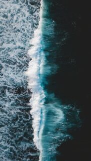 Stunning Aerial View of Crashing Ocean Waves Wallpaper for Mobile