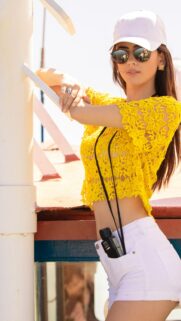 Beautiful Young Woman in Yellow Crochet Top and White Shorts Summer Portrait Wallpaper