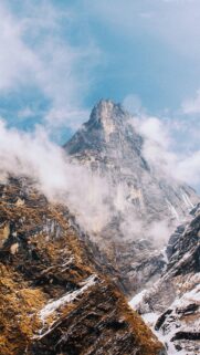 Majestic Misty Mountain Peak Under Clear Blue Sky High Resolution Mobile Wallpaper
