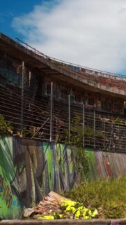Abandoned Urban Stadium with Vibrant Graffiti Street Art Mobile Wallpaper
