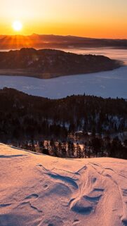 Stunning Sunrise Over Snow Covered Mountains and Frozen Lake Mobile Wallpaper
