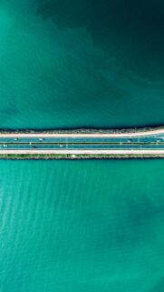 Stunning Aerial View of Coastal Highway Bridge over Turquoise Ocean Wallpaper