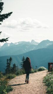 Woman Hiking Mountain Path Scenic Nature Adventure Phone Wallpaper