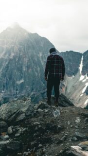Lone Hiker Standing on Mountain Peak Phone Wallpaper