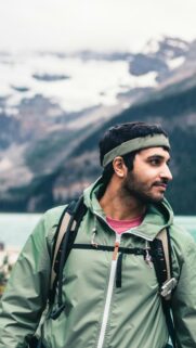Adventurous Hiker with Mountain View Portrait Mobile Wallpaper