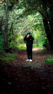 Mysterious Forest Wanderer with Oni Mask Phone Wallpaper