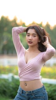 Beautiful Asian Girl With Pink Top and Jeans Portrait Wallpaper