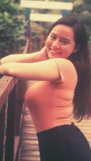 Beautiful Asian Girl Smiling on a Wooden Bridge Mobile Wallpaper