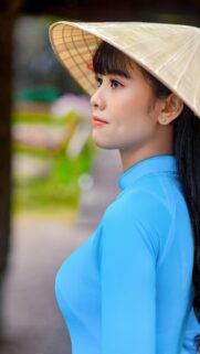 Stunning Vietnamese Woman in Blue Ao Dai and Conical Hat Wallpaper