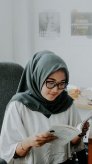 Studious Woman Reading Book in Hijab Aesthetic Mobile Wallpaper