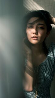 Stunning Asian Woman with Sunlight Shadows Aesthetic Mobile Wallpaper