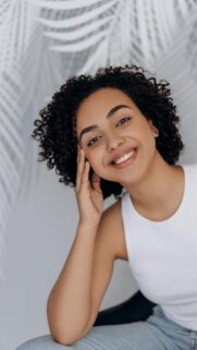 Beautiful Smiling Woman with Curly Hair Phone Wallpaper